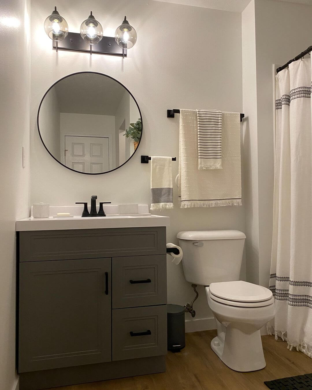 Ground Your Space with a Dark Gray Vanity and Black Hardware