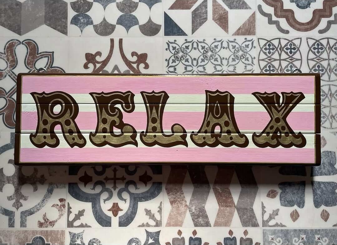 Playful 'Relax' Sign in Pink and Gold