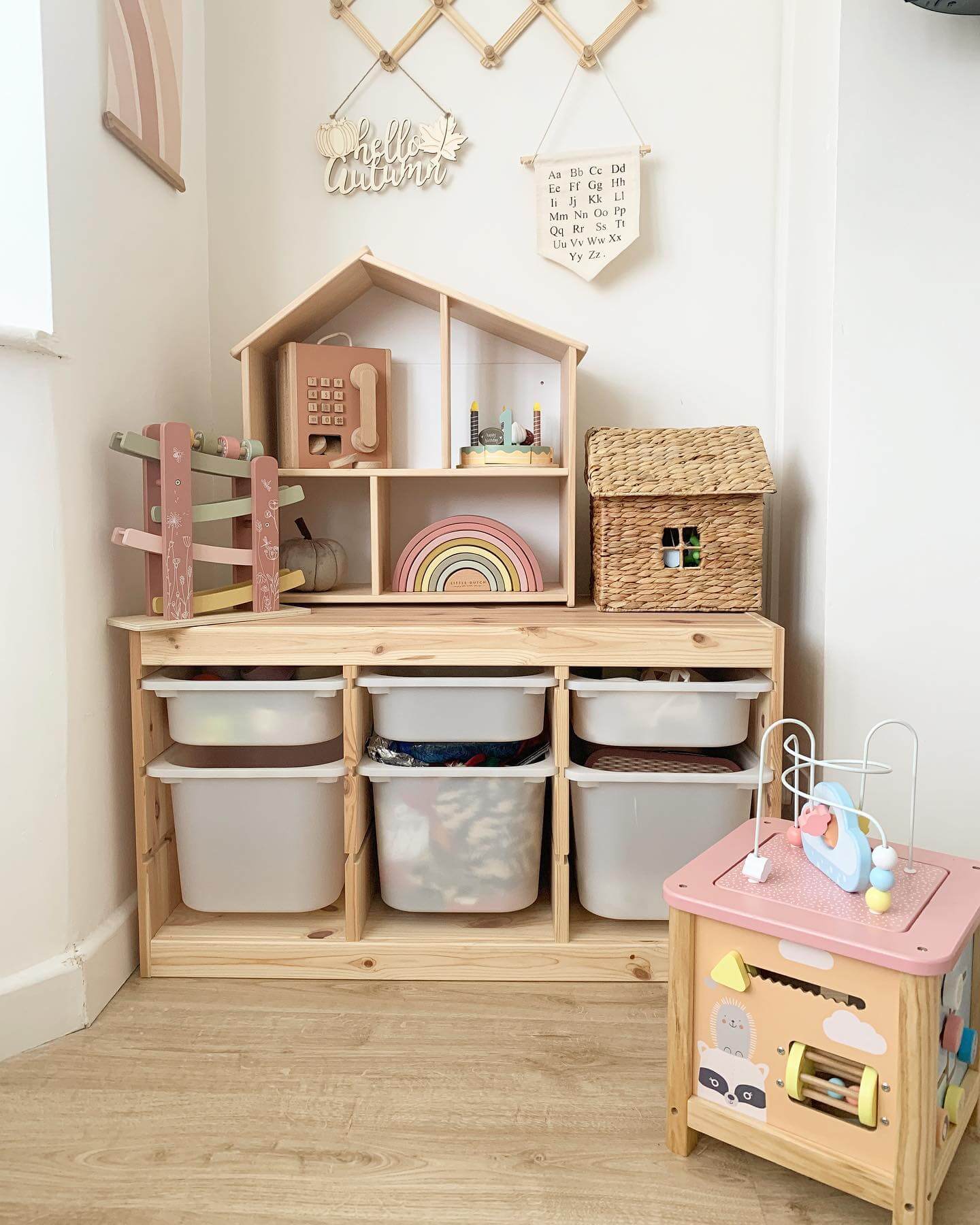 Wooden House Shelf Holds Playful Toys and Cozy Baskets