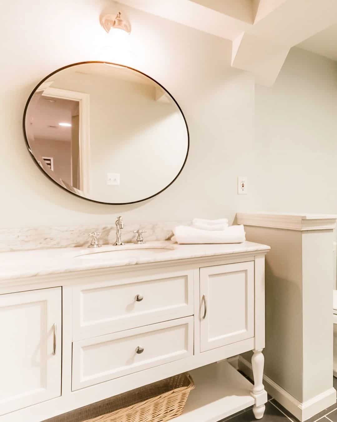 Round Mirror with Thin Black Frame Above Vanity