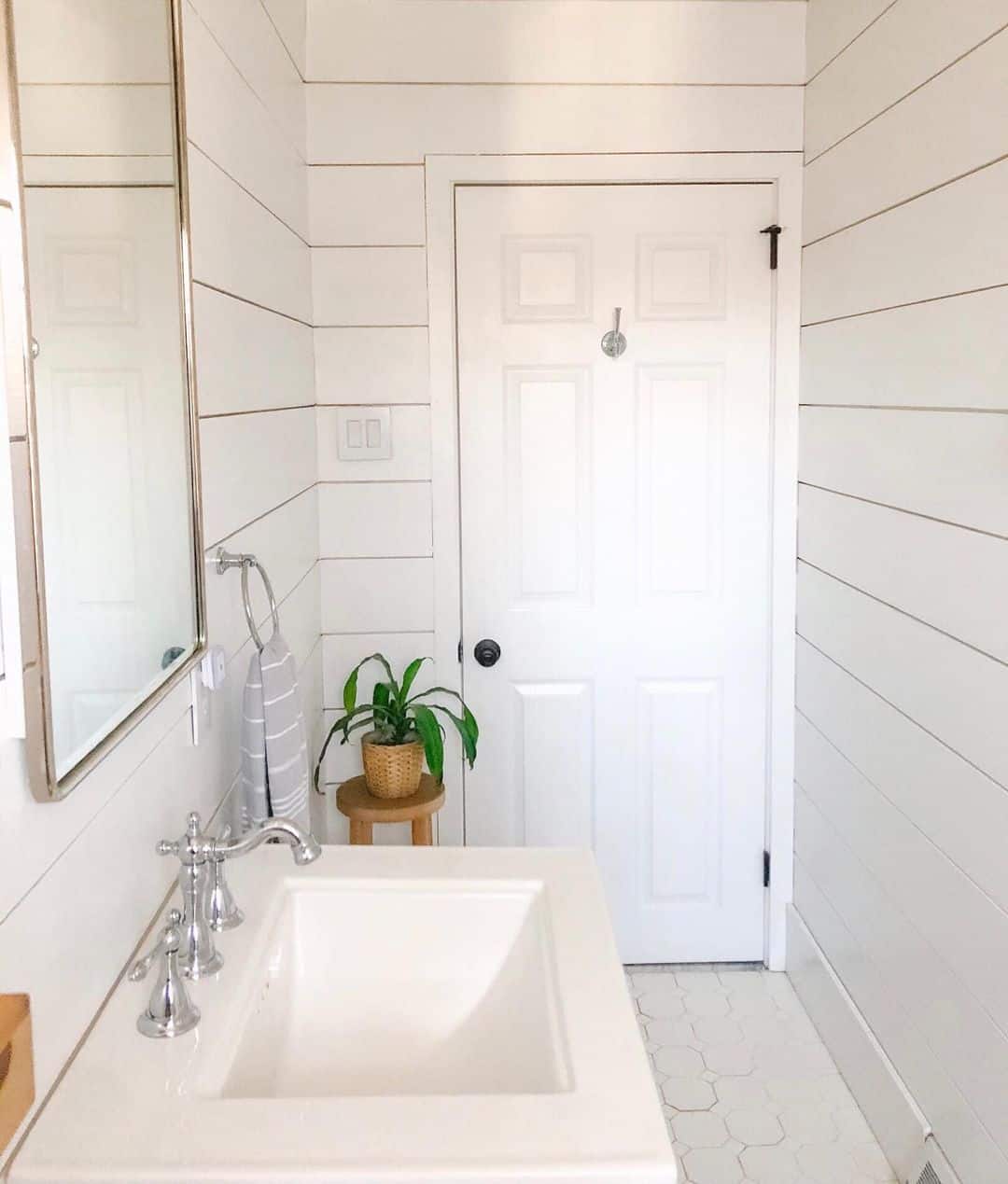 Small Wooden Stool Adds a Pop of Greenery Near the Sink