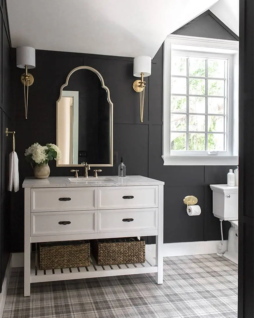 Dark Paneled Walls Frame a White Vanity and Gold Mirror