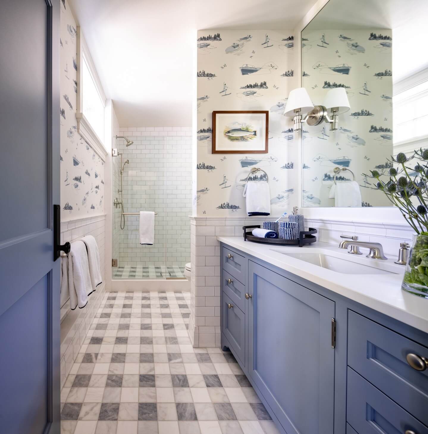 Blue Vanity With Nautical Wallpaper Creates a Coastal Vibe
