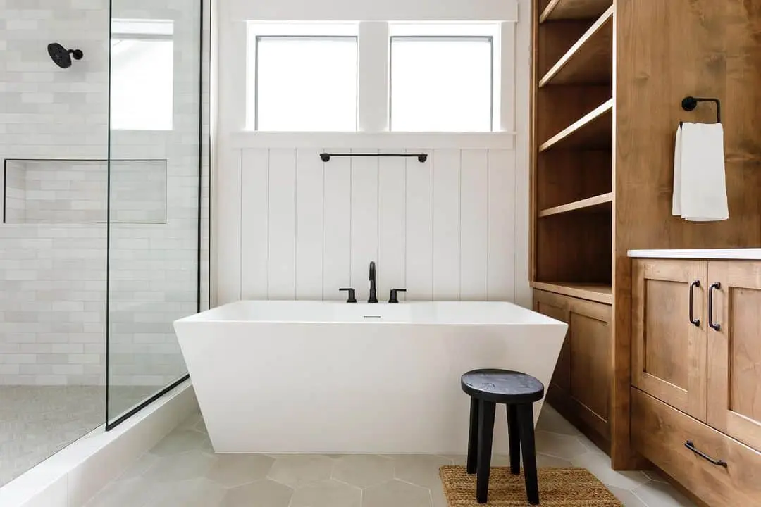 Dark Stool Adds a Grounding Element Next to the Tub