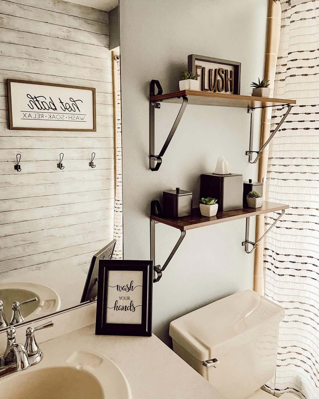 Dark Wood Shelves Hold Black Containers and Small Greenery