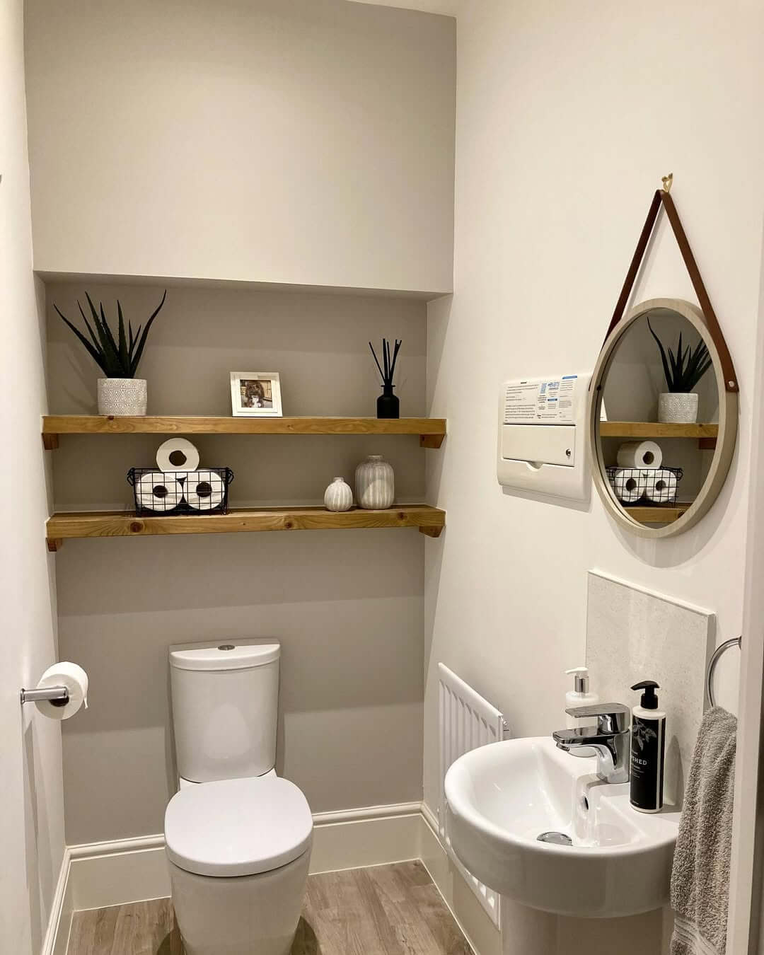 Wooden Shelves Display Black Wire Baskets of Toiletries