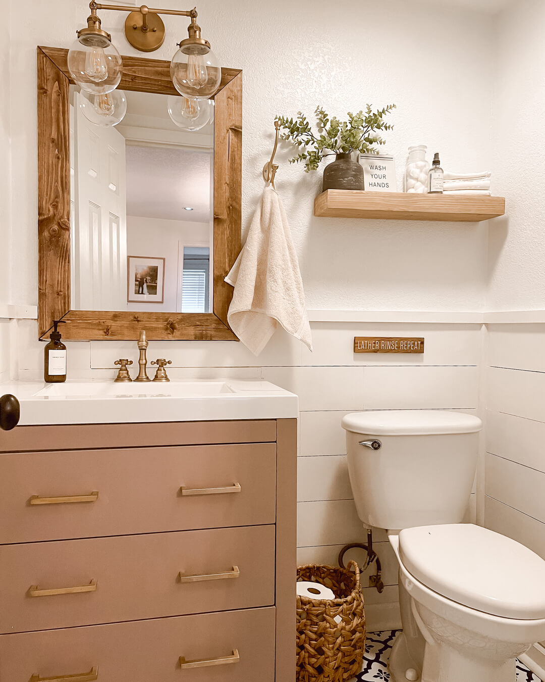 Wooden Shelf With Rustic Hooks Holds Greenery and Towels
