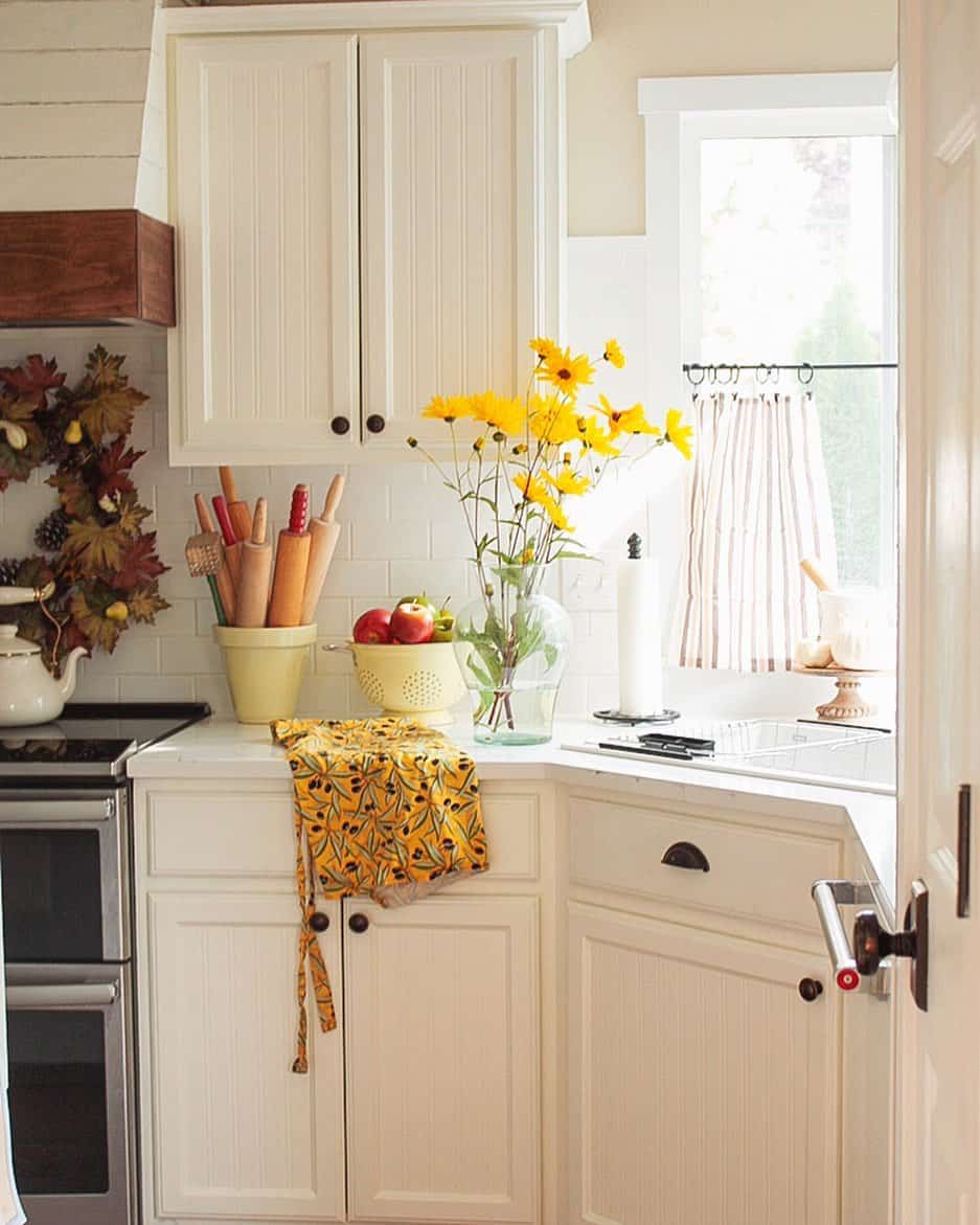 Classic Cream Beadboard Cabinets with Simple Black Knobs
