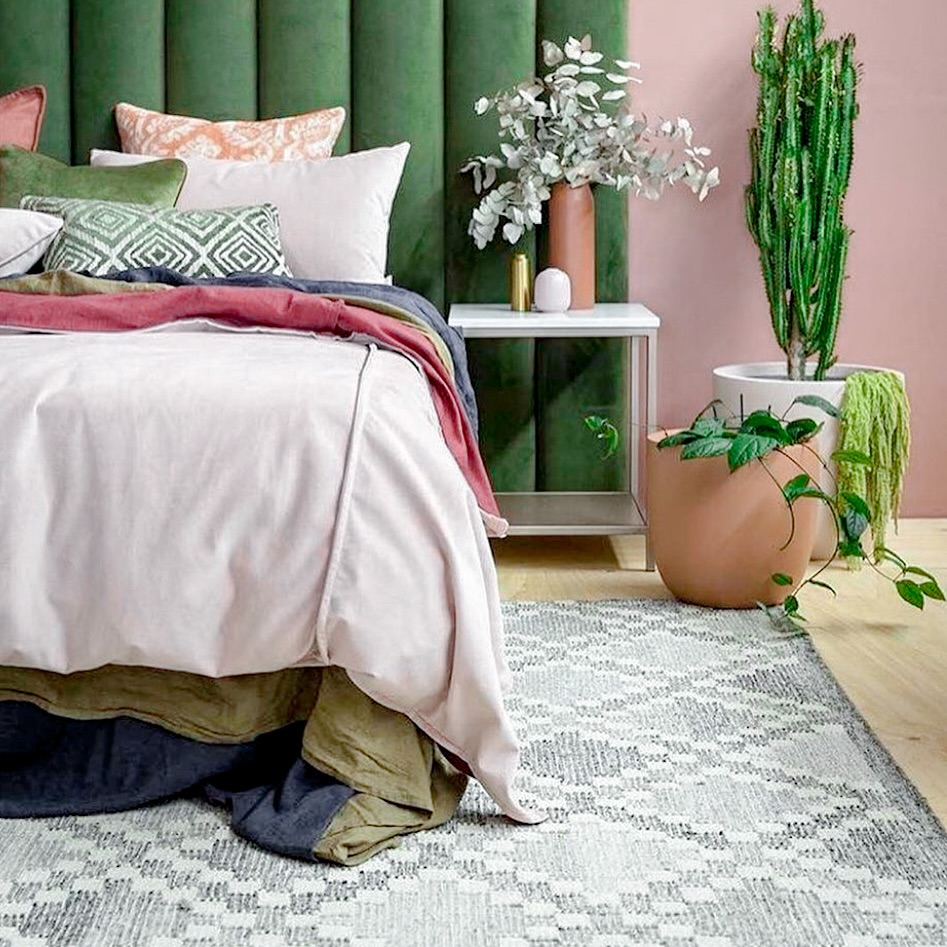 Geometric Gray Rug Underneath Soft Pink Bedding