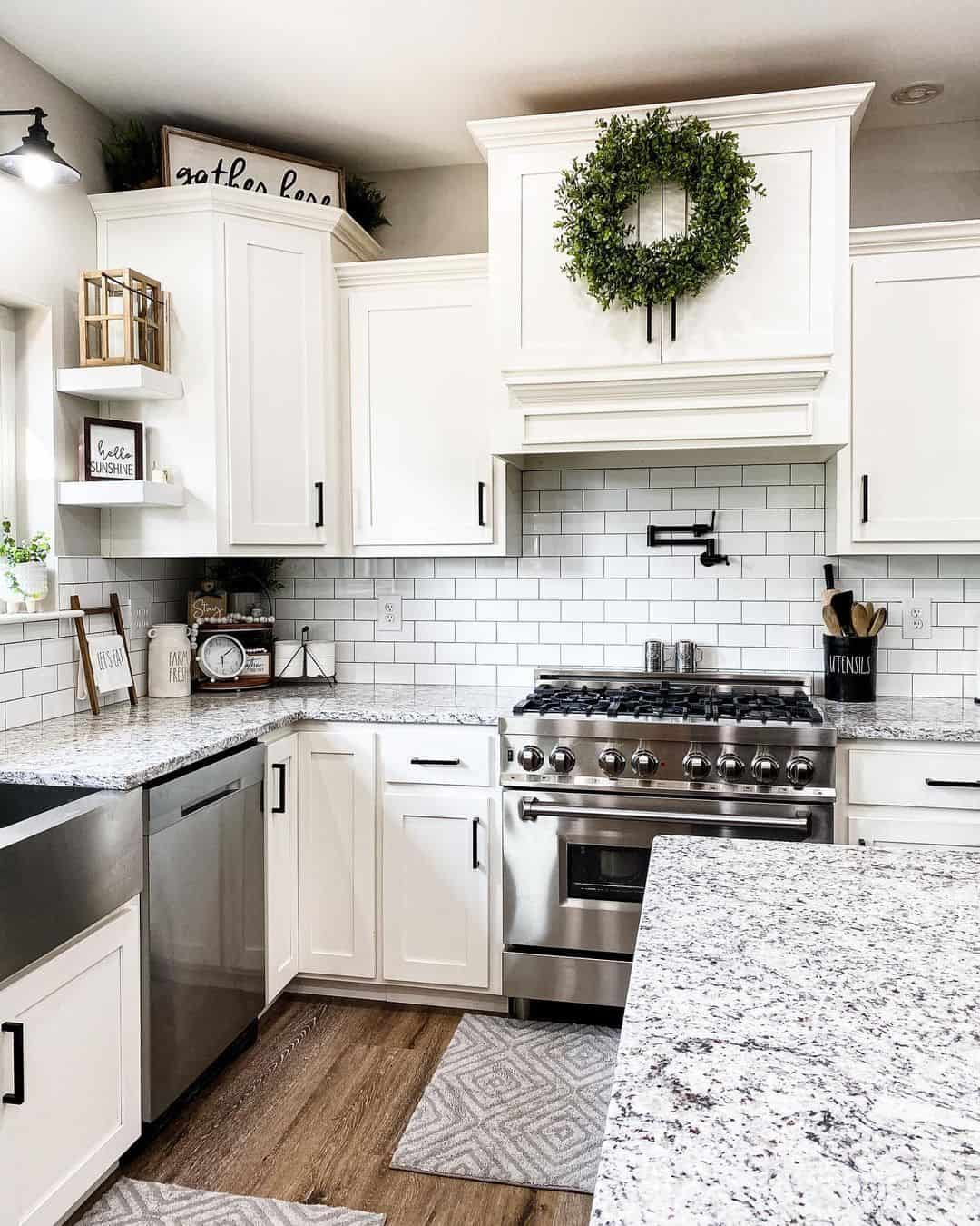 White Kitchen Cabinets With A Greenery Wreath