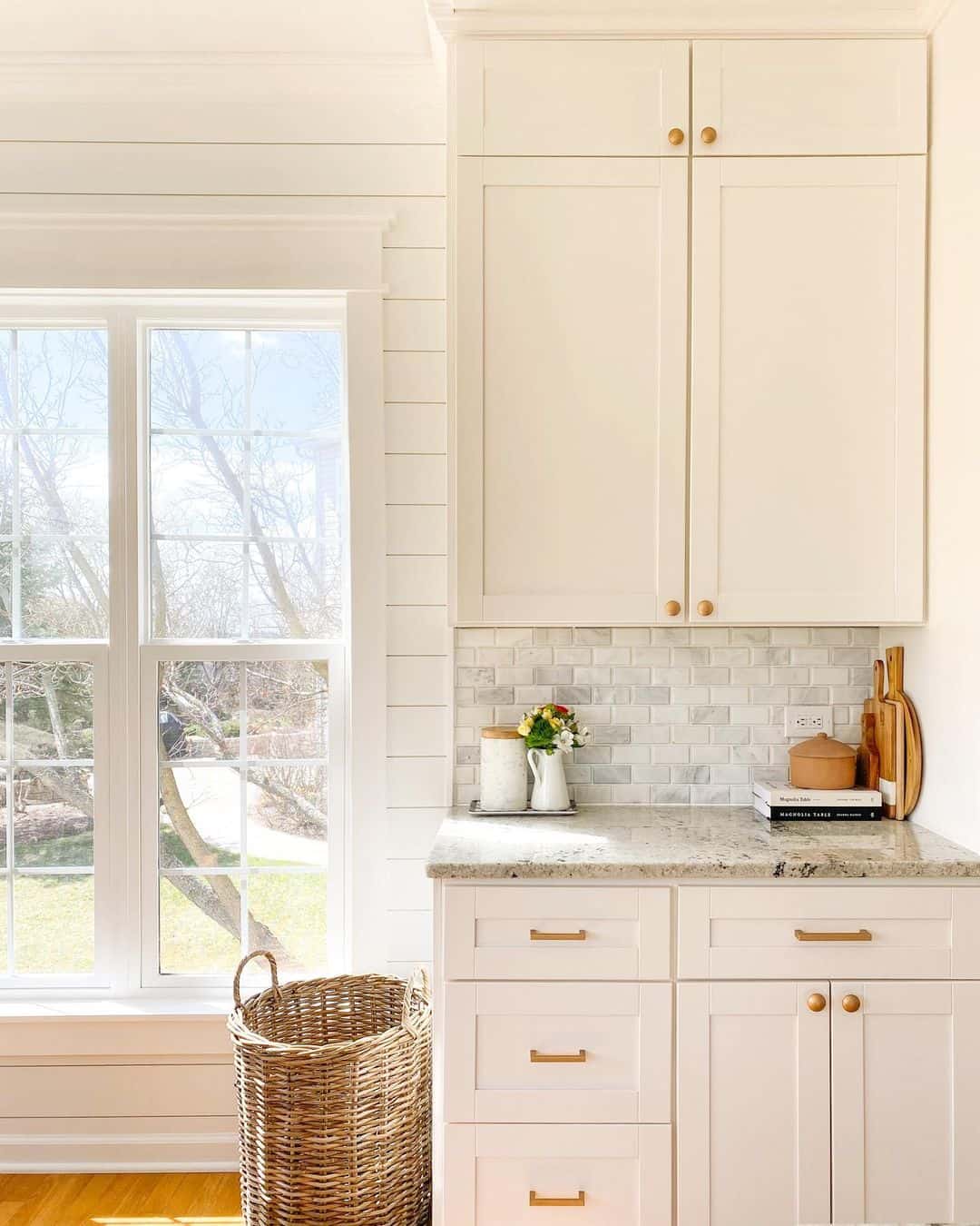 White Shaker Cabinets with Brass Knobs Add Warmth