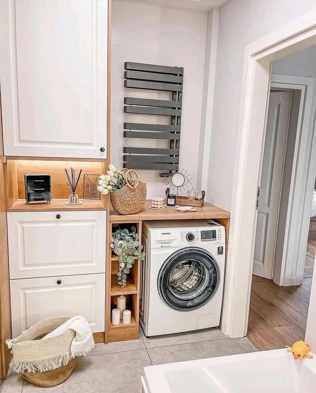 Wooden Shelving Unit Holds Plants and Candles Next to Washer