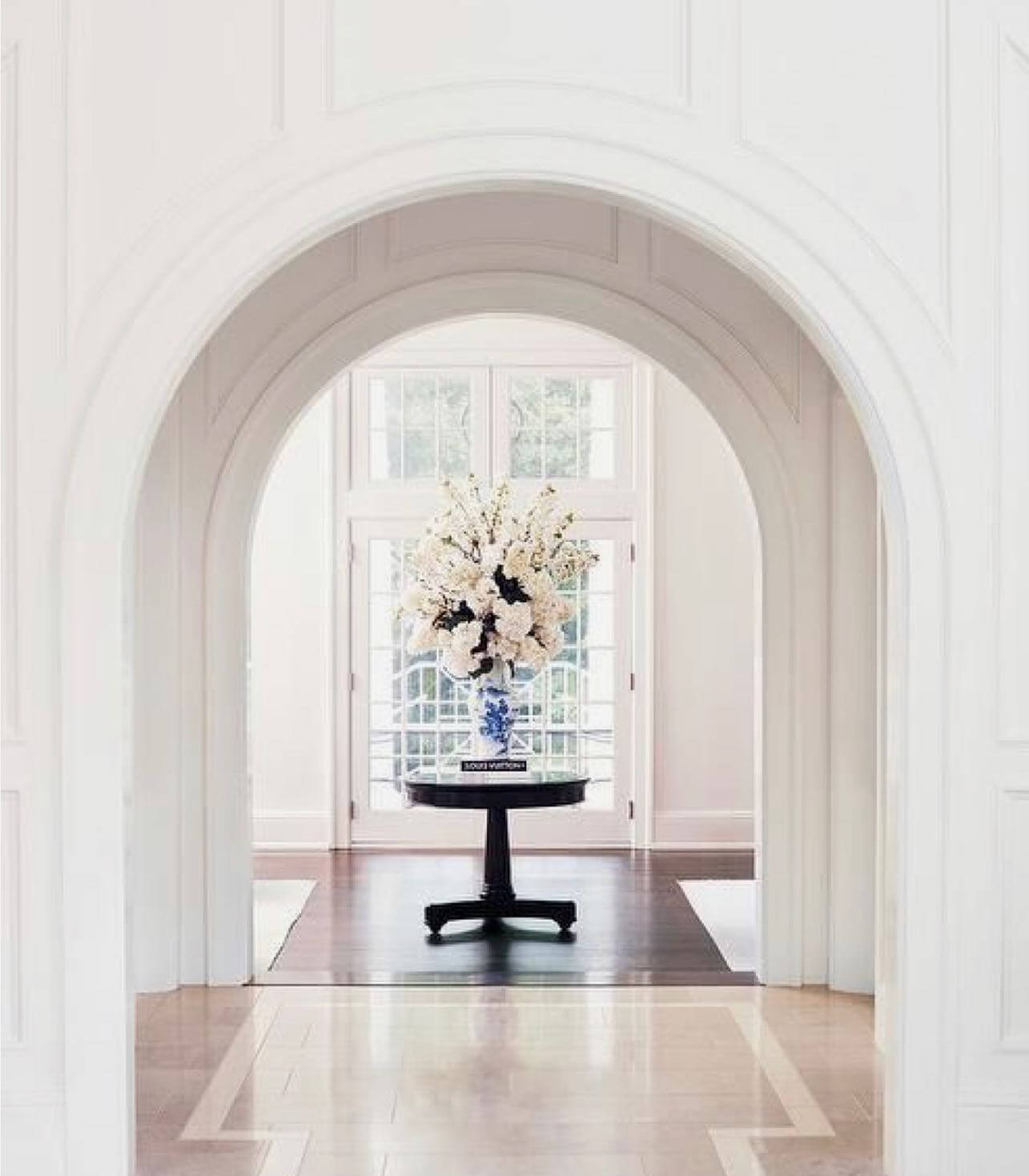 Dark Round Table with Blue and White Vase of Flowers