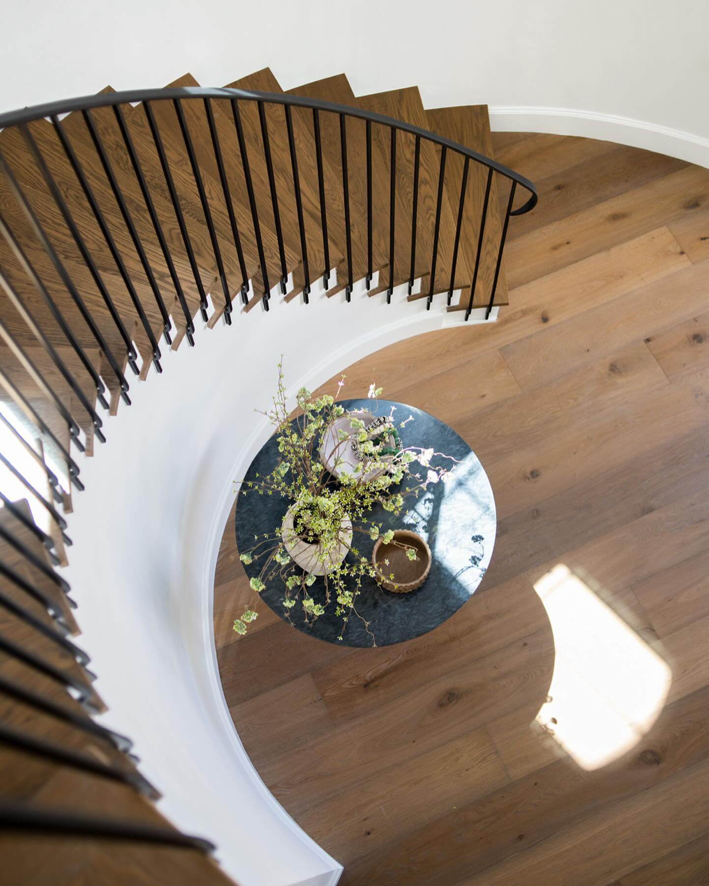 Dark Marble Round Table with Airy Greenery