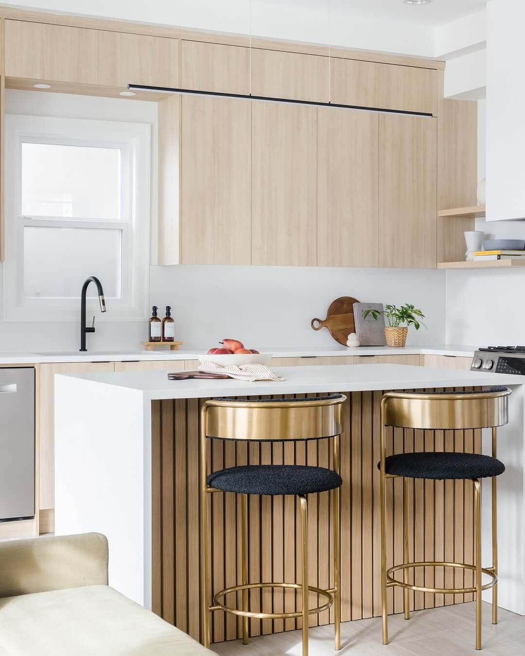 Thin Linear Pendant Light Illuminates White Oak Kitchen