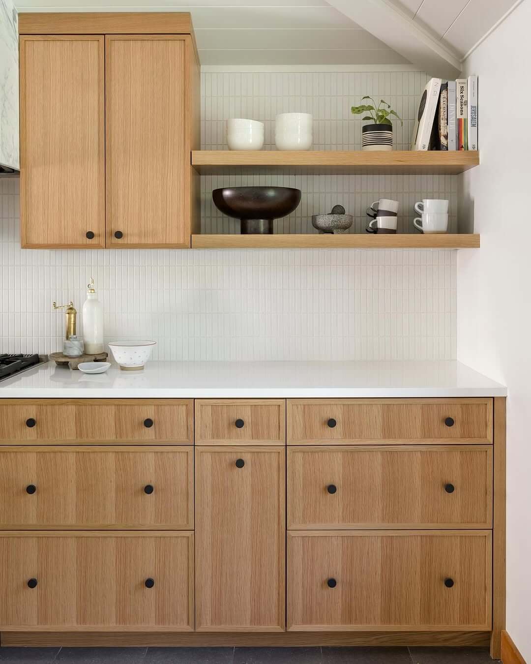Simple Black Knobs Provide Contrast on Light Wood Cabinets
