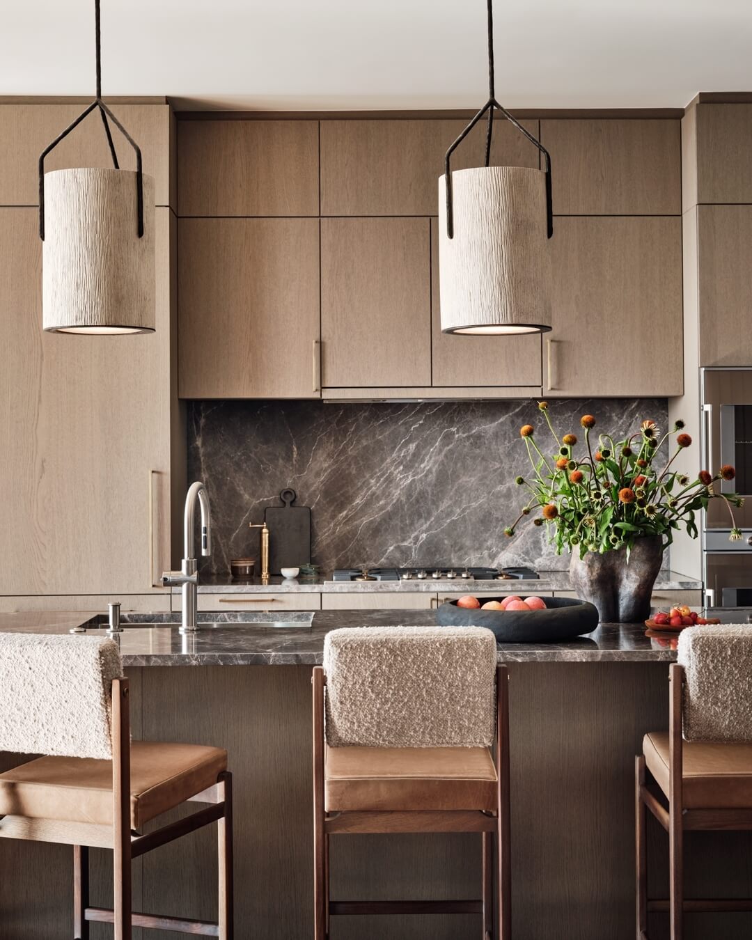 Textured Drum Pendants Soften Sleek White Oak Cabinetry