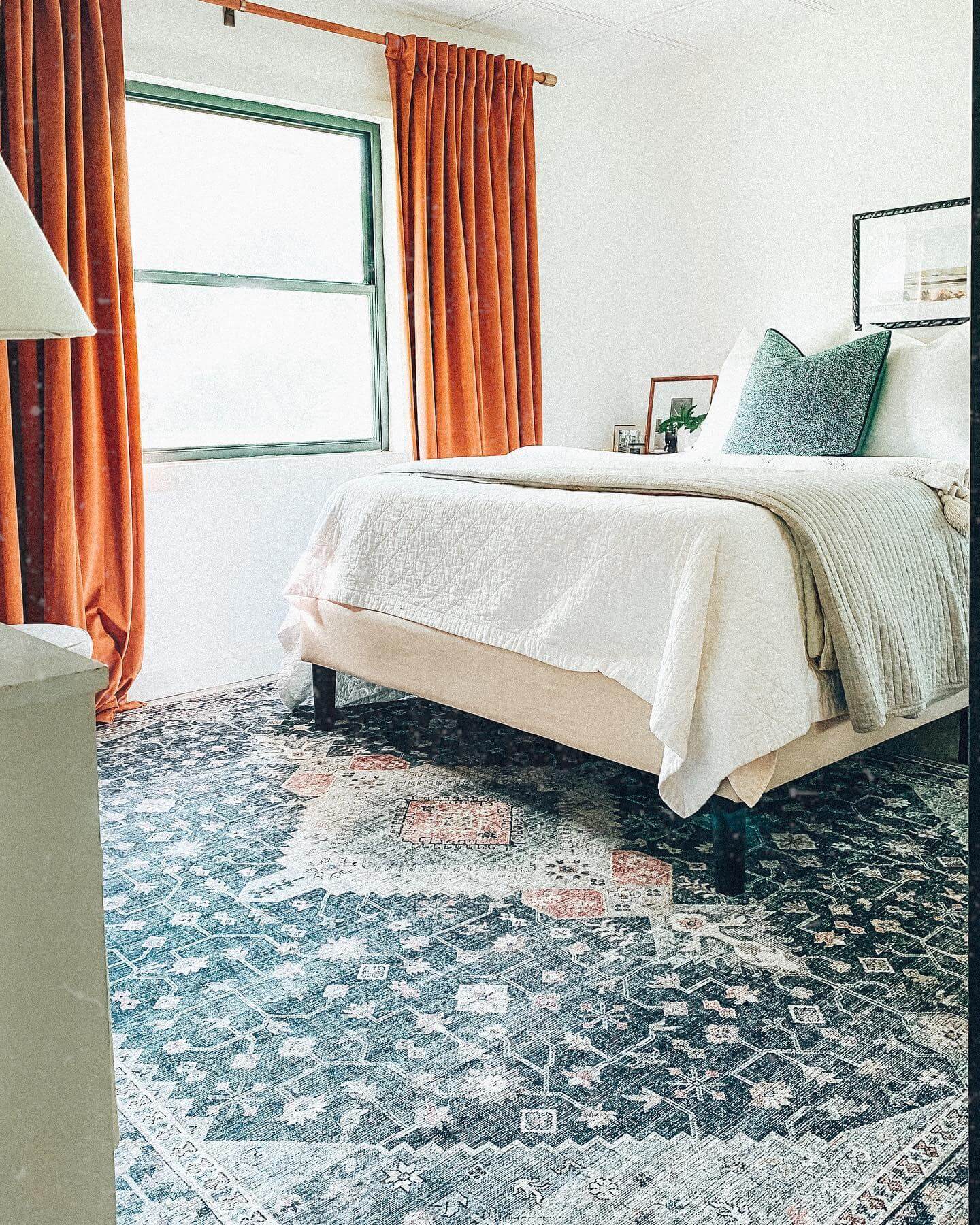 Ground Your Bed with a Dark, Patterned Rug for Warmth
