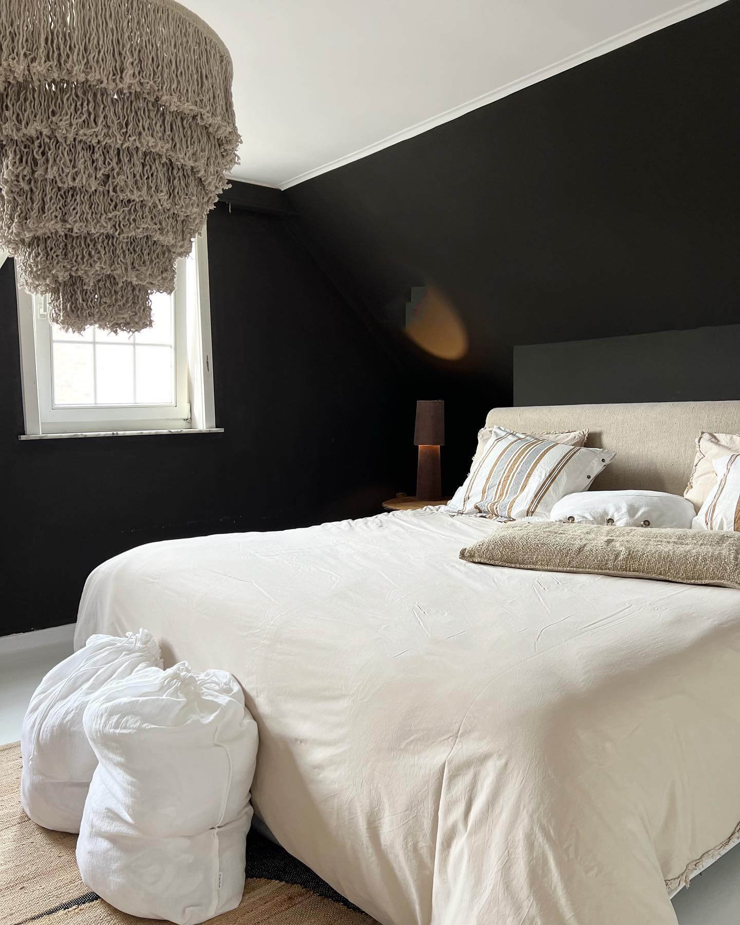 Macrame Chandelier Softens a Dramatic Black Wall