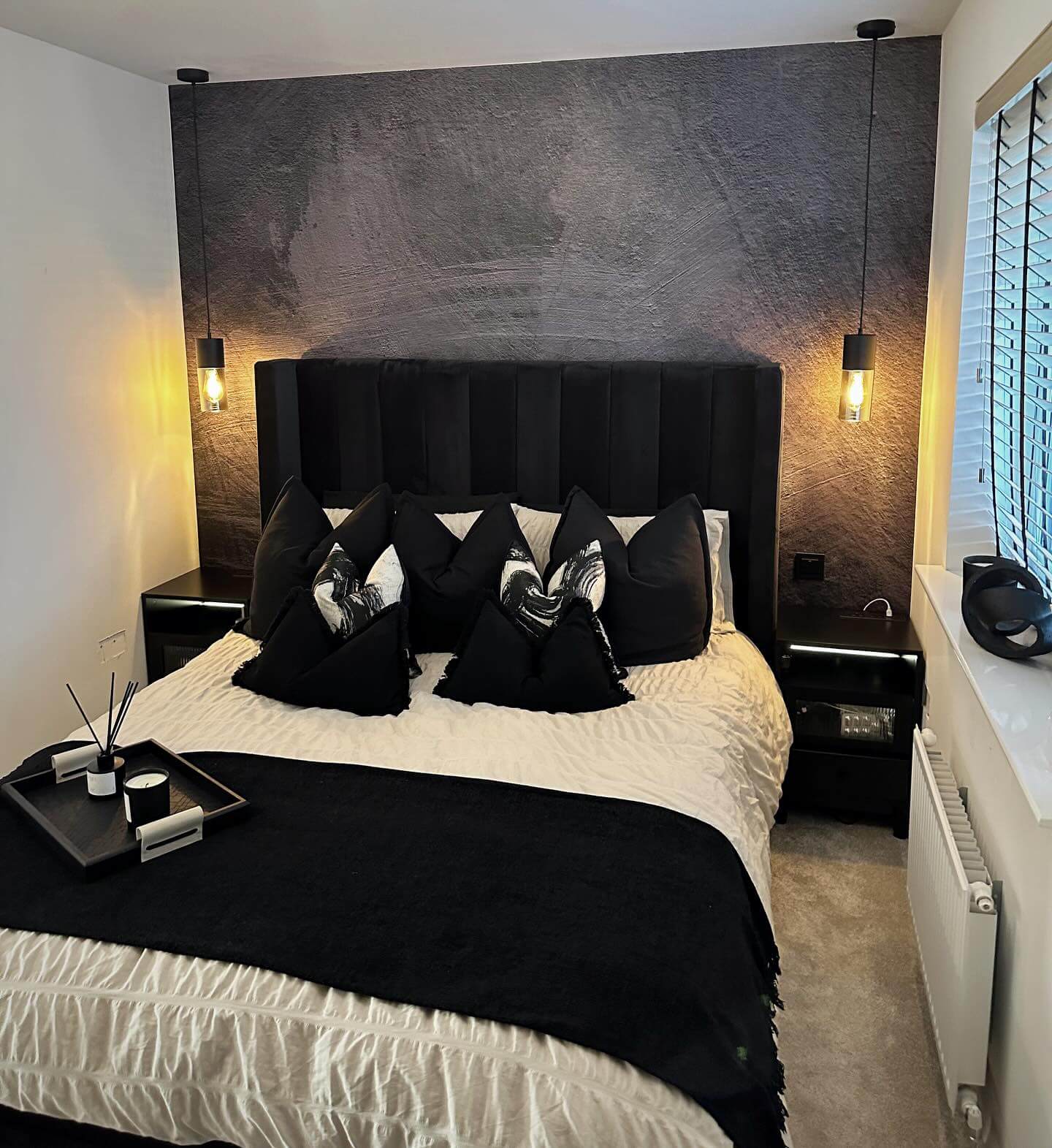 Textured Black Wall with Minimalist Pendant Lights