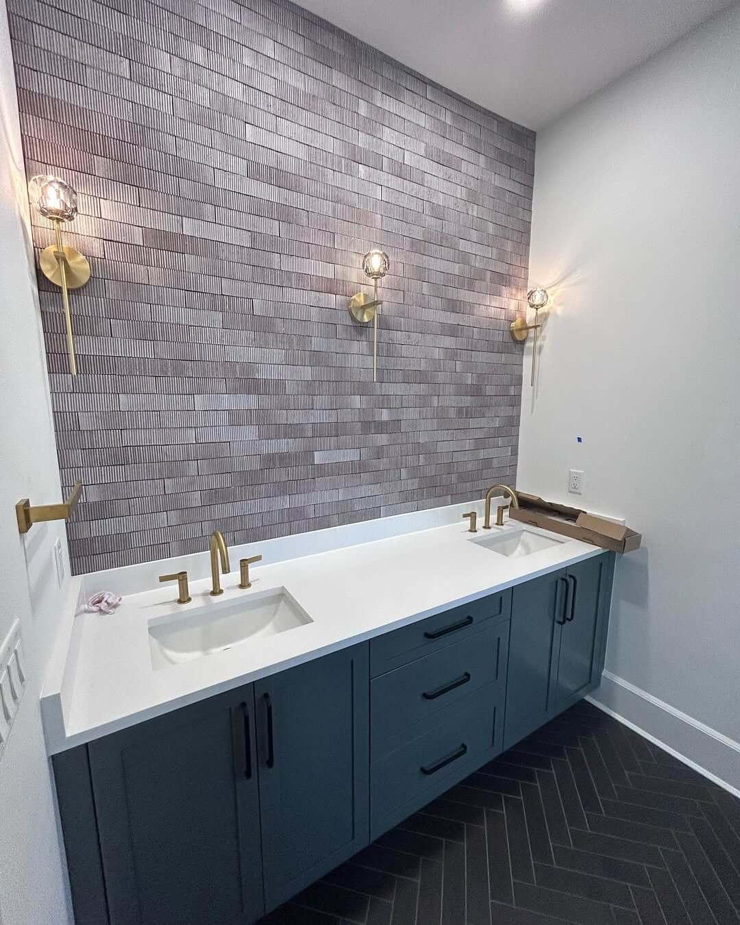 Vertically Stacked Black Tiles Add Depth Behind Double Vanities