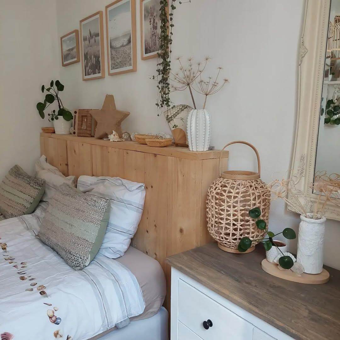 Wooden Headboard Shelf Displays Beachy Artwork and Natural Accents