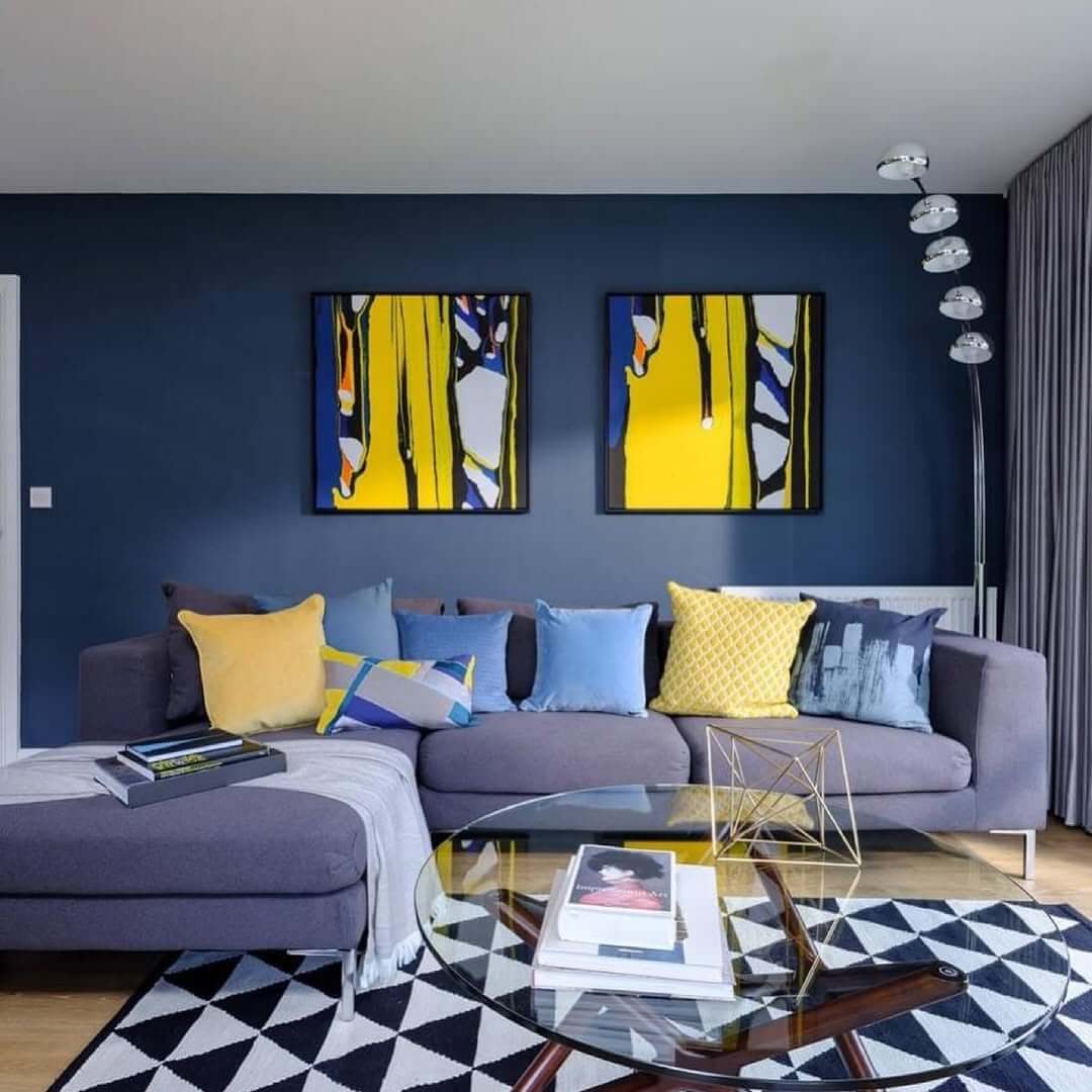 Bold Yellow Art Pieces Accent a Deep Blue Wall