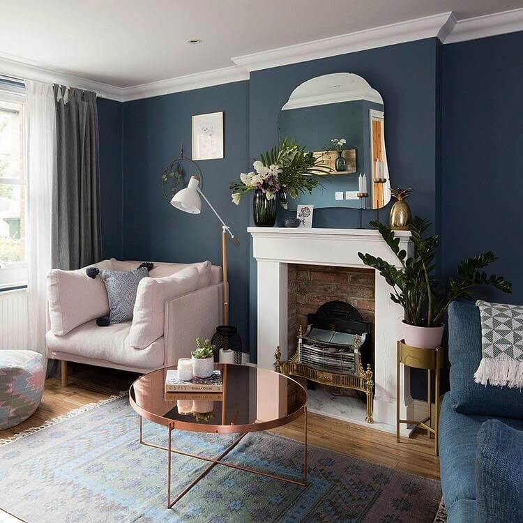 Mirrored Arch Adds Depth Above a White Mantel
