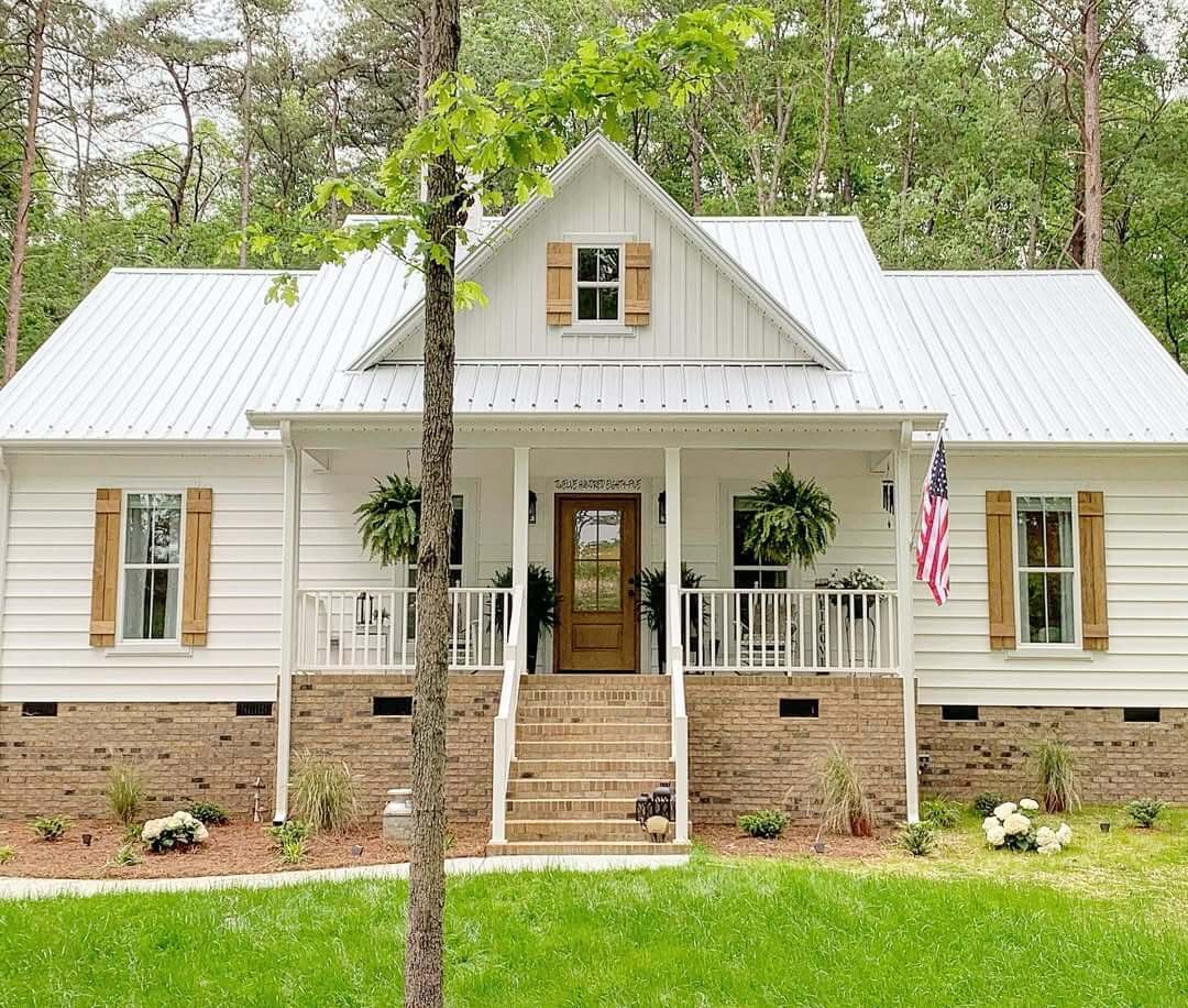 Wood Plank Shutters Frame Windows on White Farmhouse