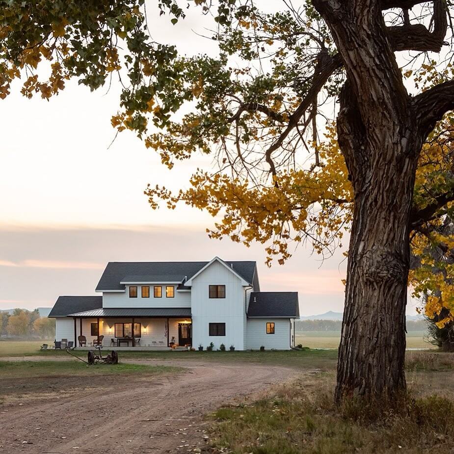 Deep-Set Windows Create Shadow Play on White Farmhouse Walls