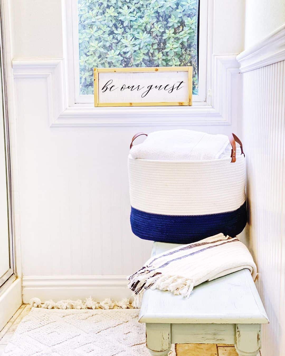 Two-Tone Rope Basket Holds Rolled Towels Beside the Window