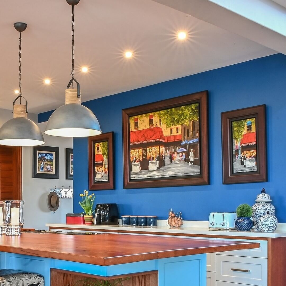 Framed European Street Scenes Add Old-World Charm to Blue Walls