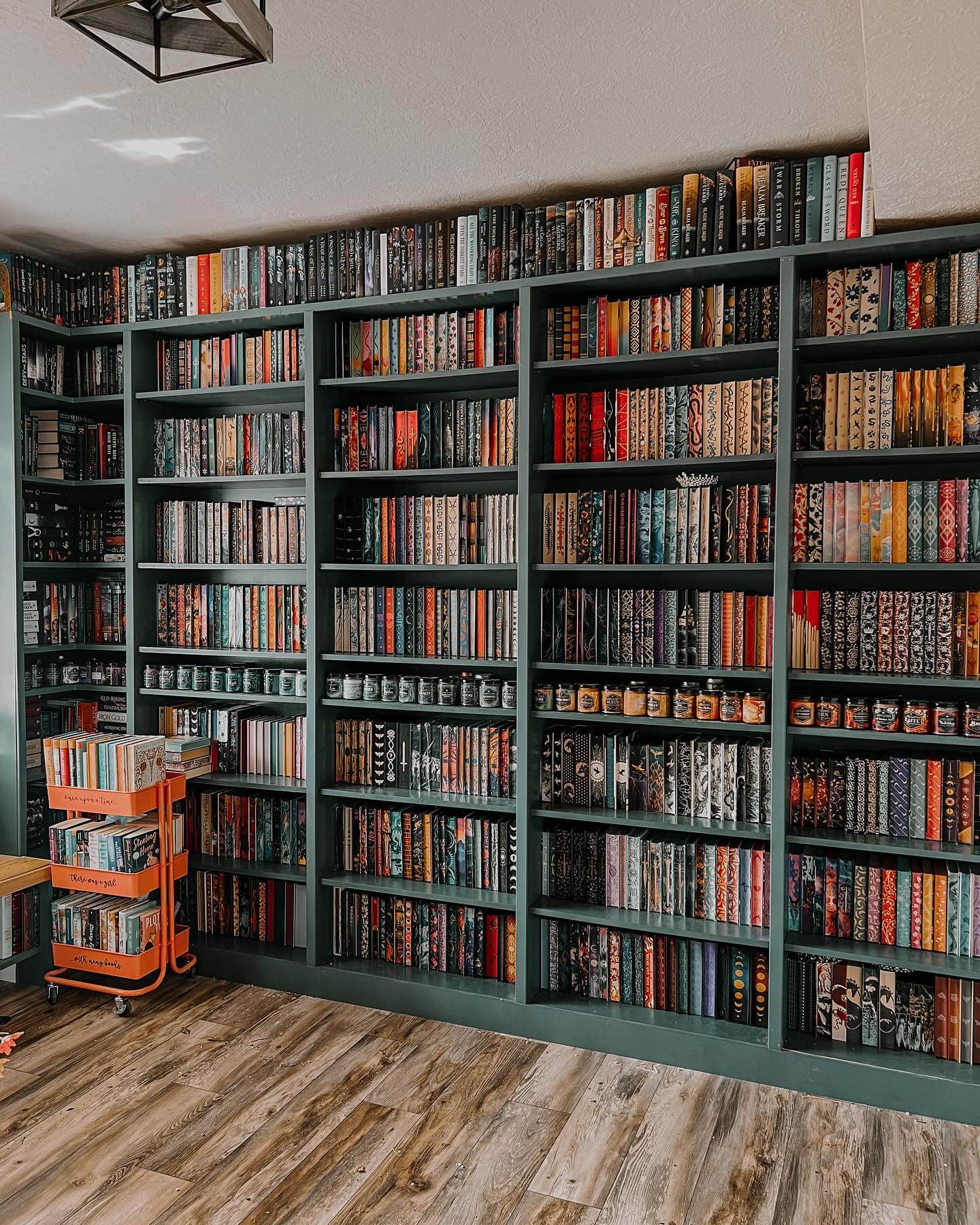 Deep green built-in bookshelves with varied book spines