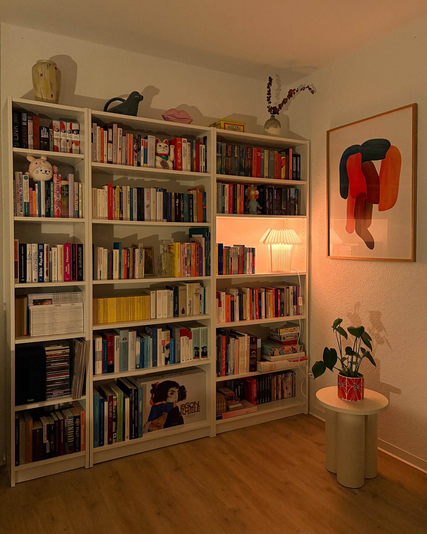 Pleated Lamp Creates a Warm Glow on Bookshelf