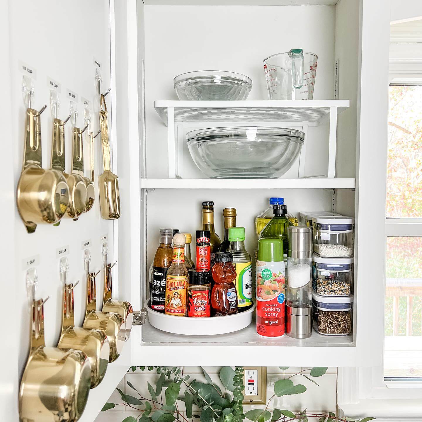 Gold Measuring Cups Hang on Clear Hooks for Easy Access