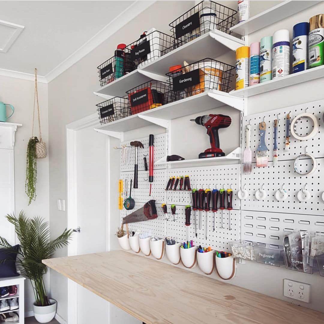 White Ceramic Cups Hold Pens and Brushes on Workbench