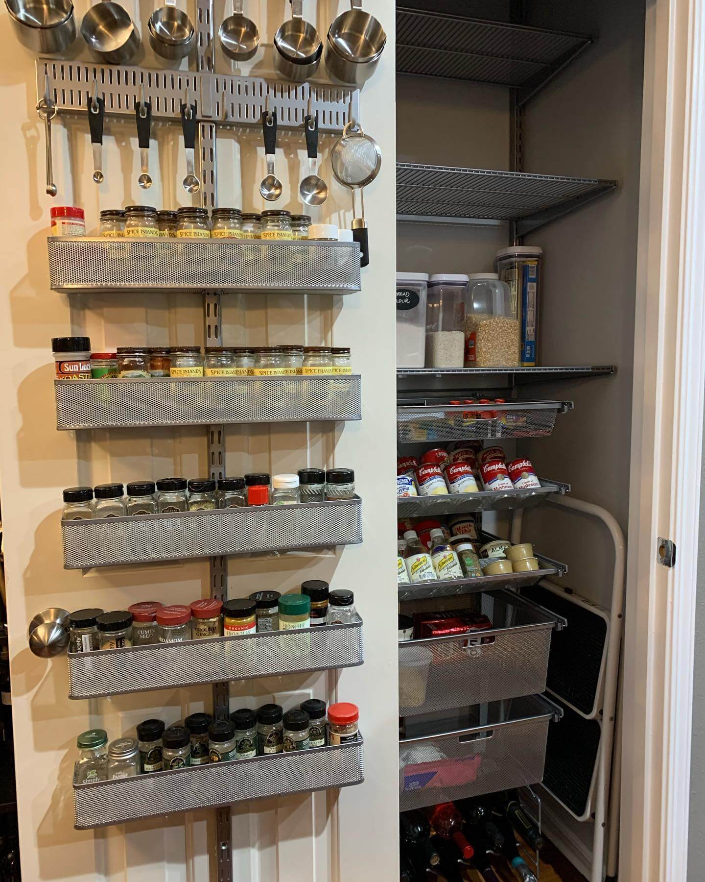 Mesh Baskets on Wall-Mounted Rails Hold Pantry Jars