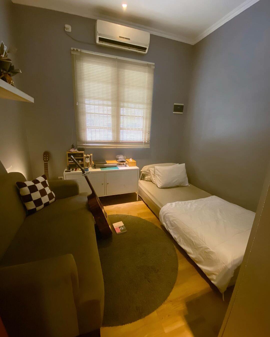 Narrow Bed and Sofa Create a Cozy Lounge Area