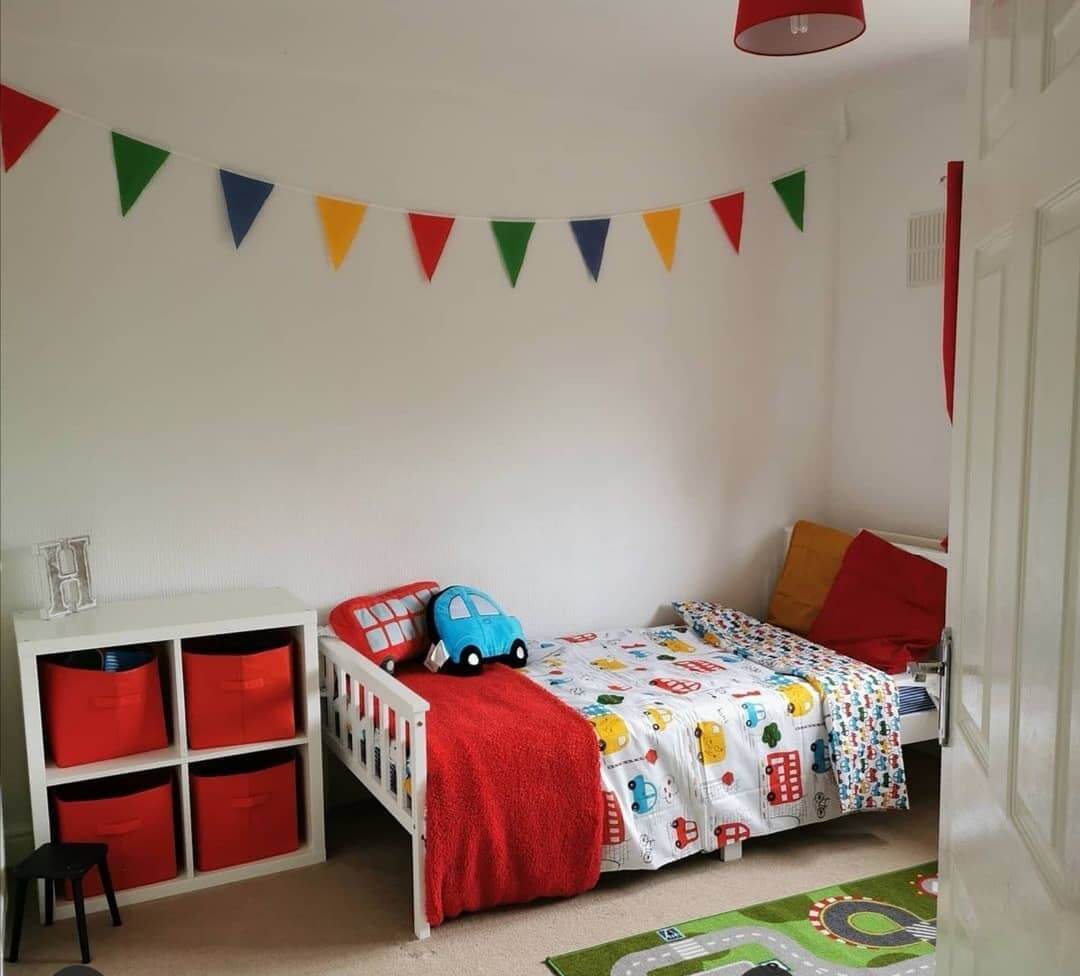Colorful Bunting Adds Instant Festive Cheer to a Small Bedroom
