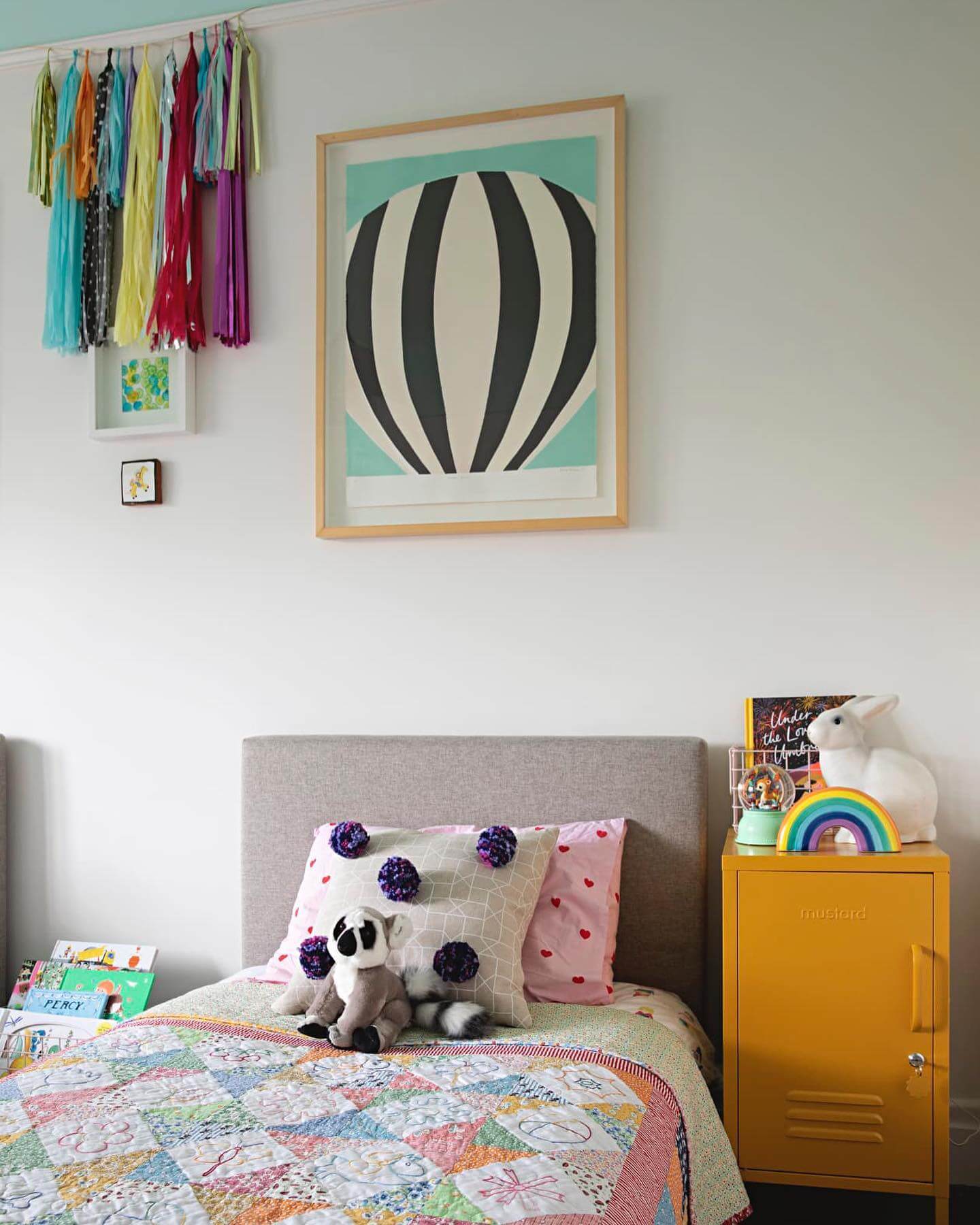 Hanging Tassel Garland Adds a Pop of Color Above the Bed