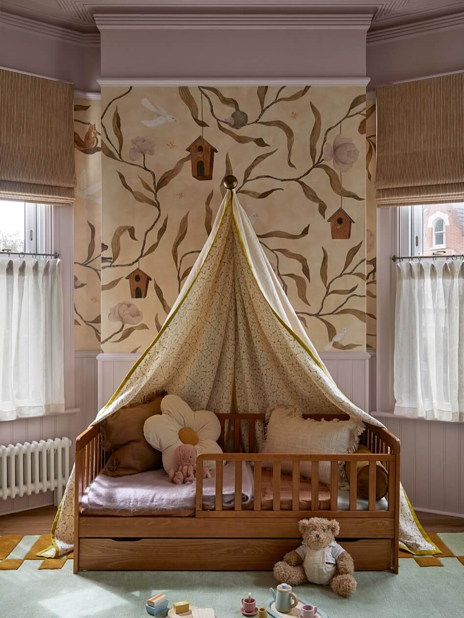 Wood toddler bed with a whimsical nature mural