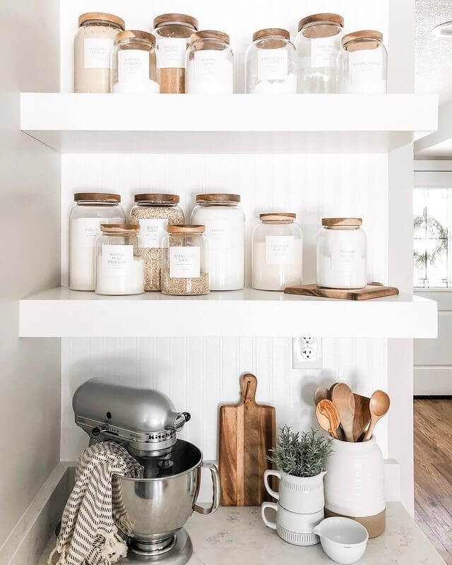 Glass jars with wood lids create a uniform pantry look