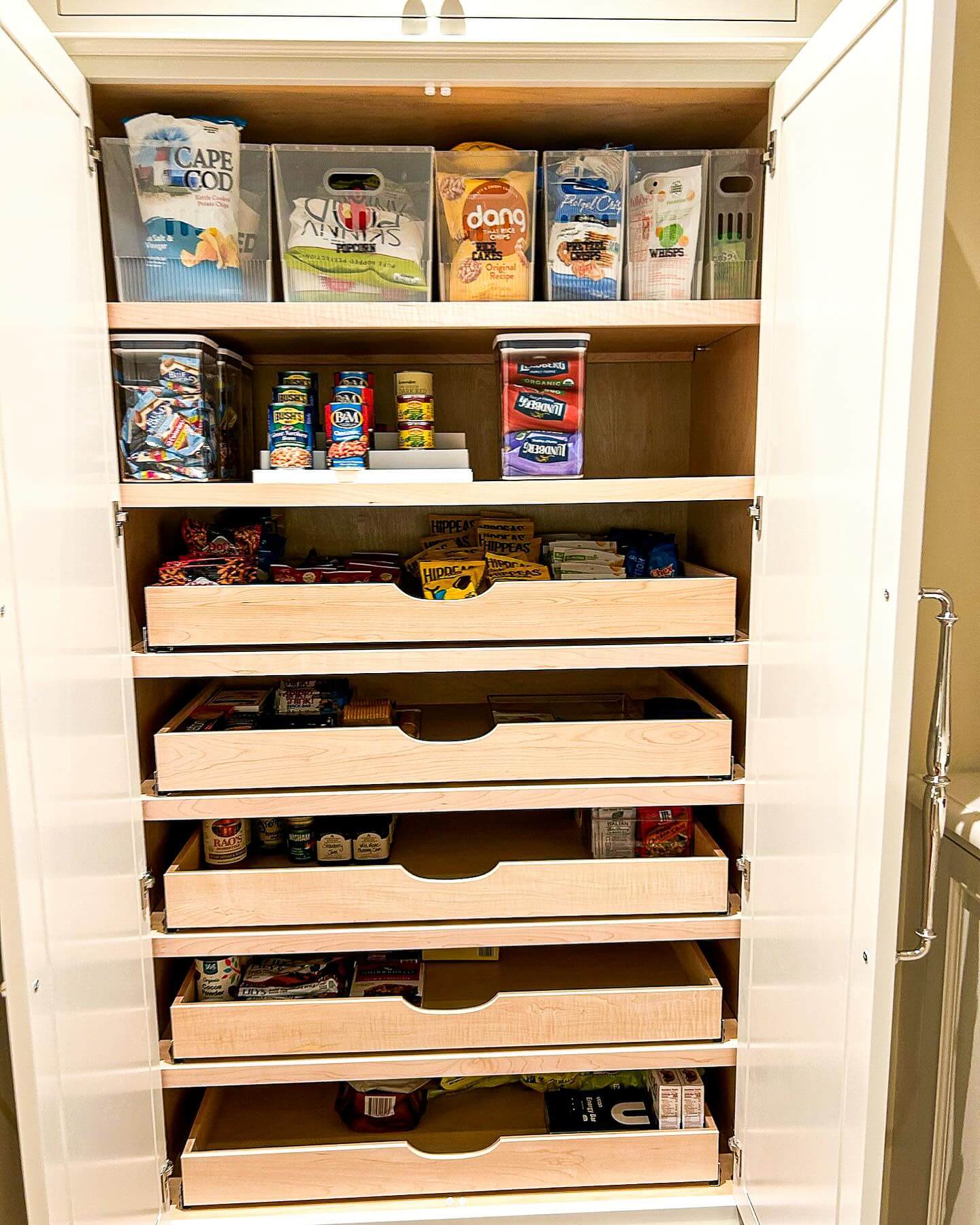 Pull-out wood drawers create a tiered pantry system