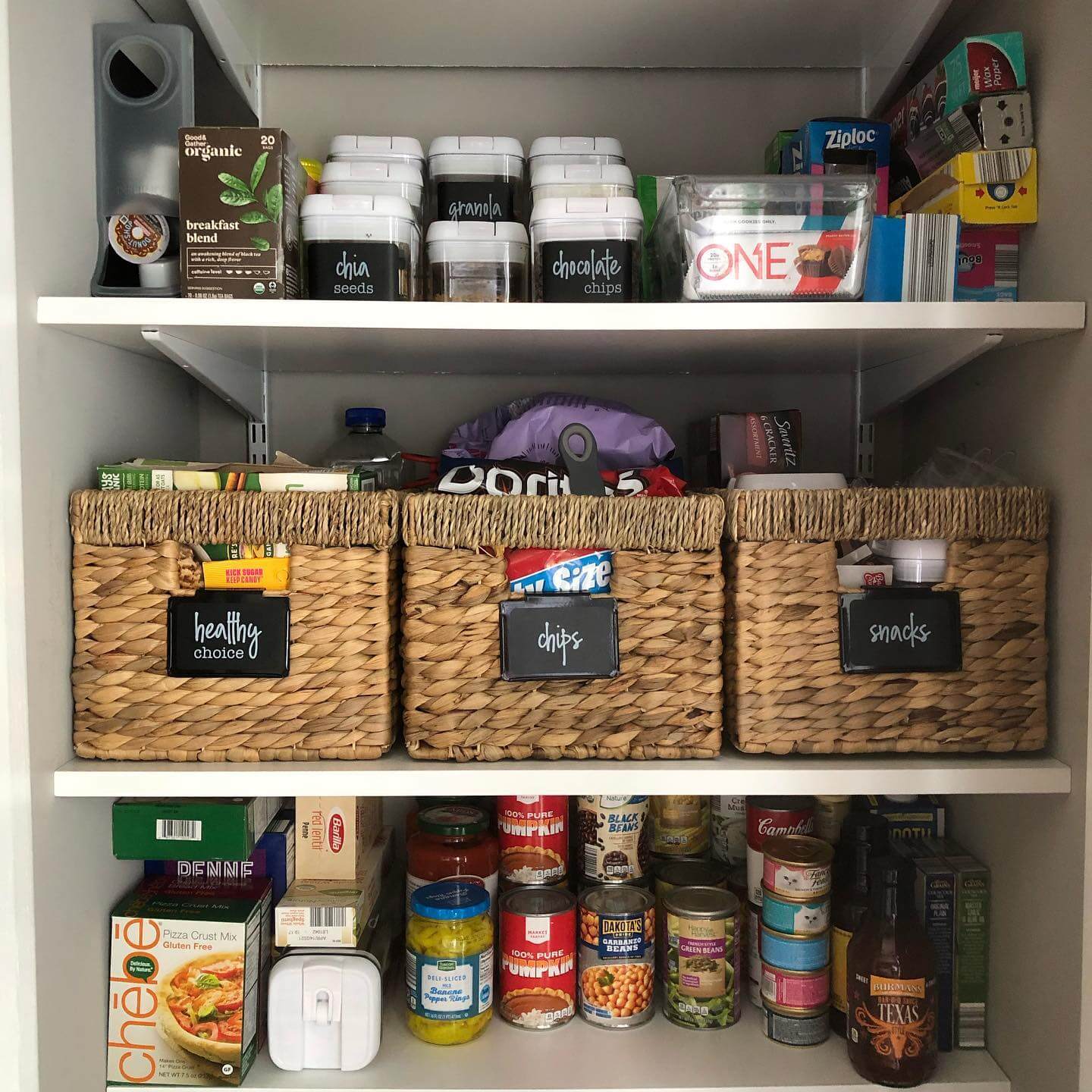 Woven baskets with chalkboard labels create distinct zones