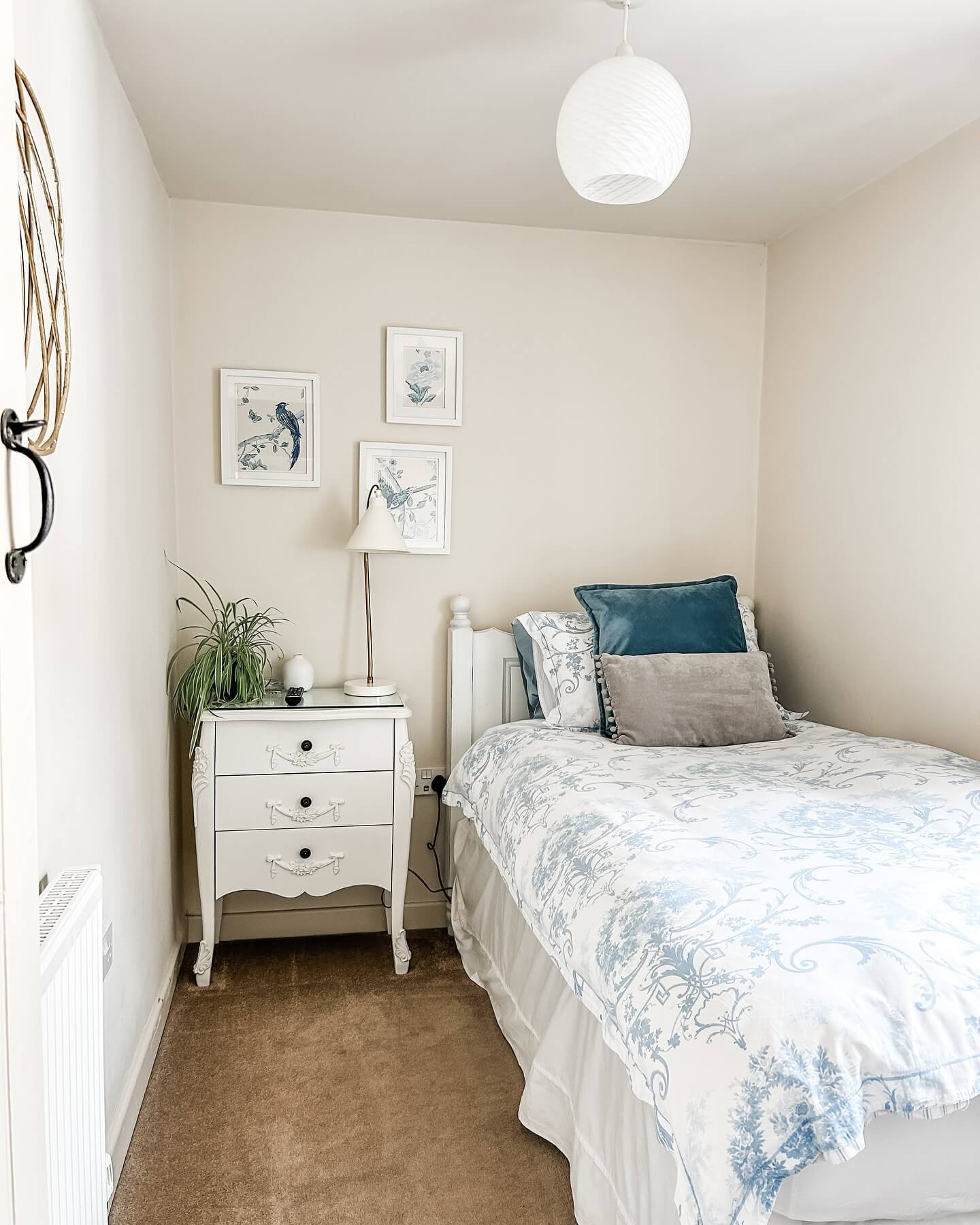 Three Framed Botanical Prints Add Delicate Charm Above the Nightstand
