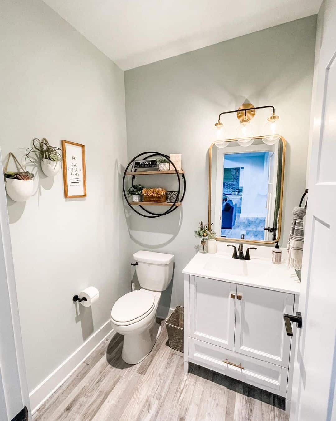 Circular Shelf Unit Adds Industrial Style Above the Toilet