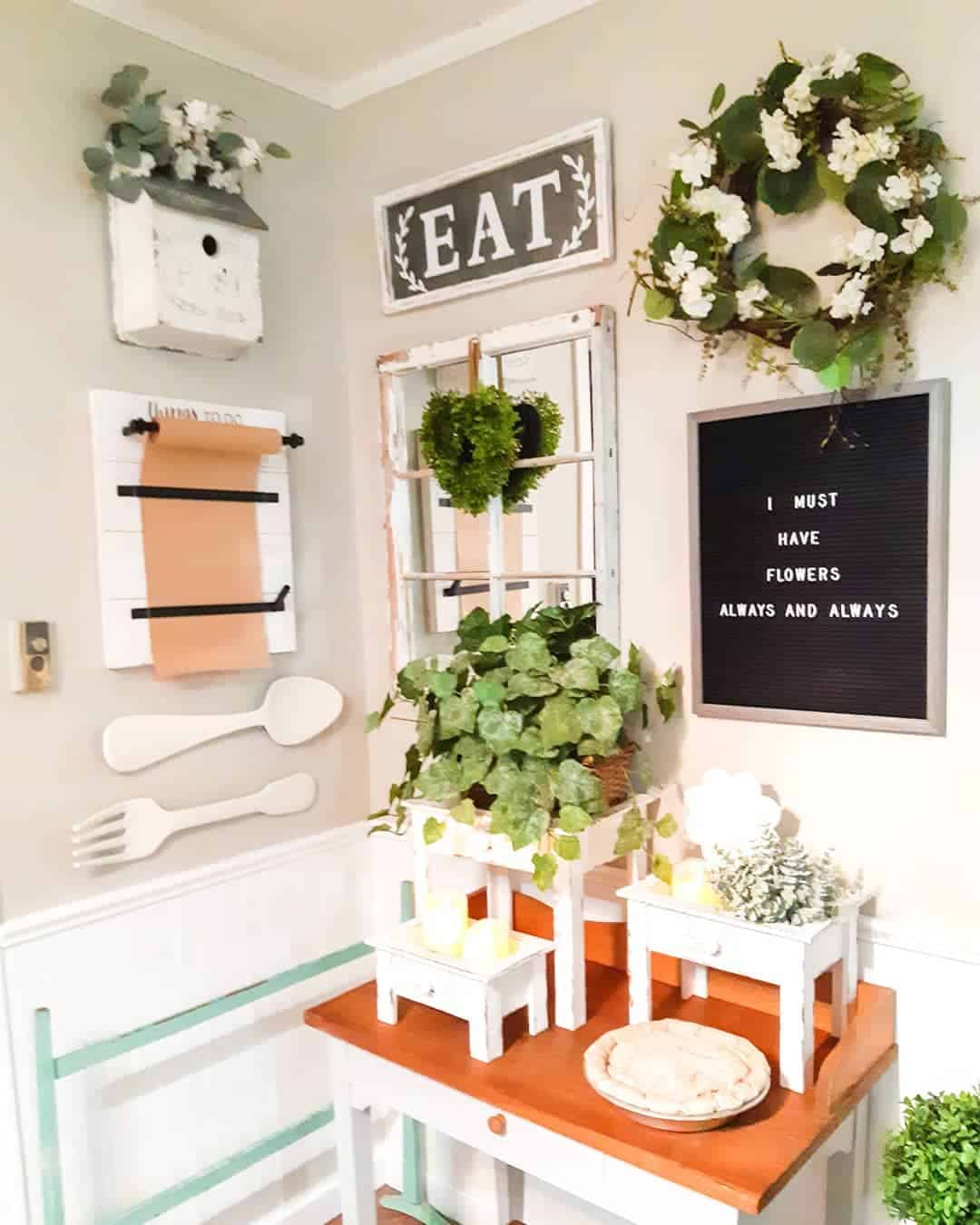 White Wooden Pedestals Display Candles and Greenery
