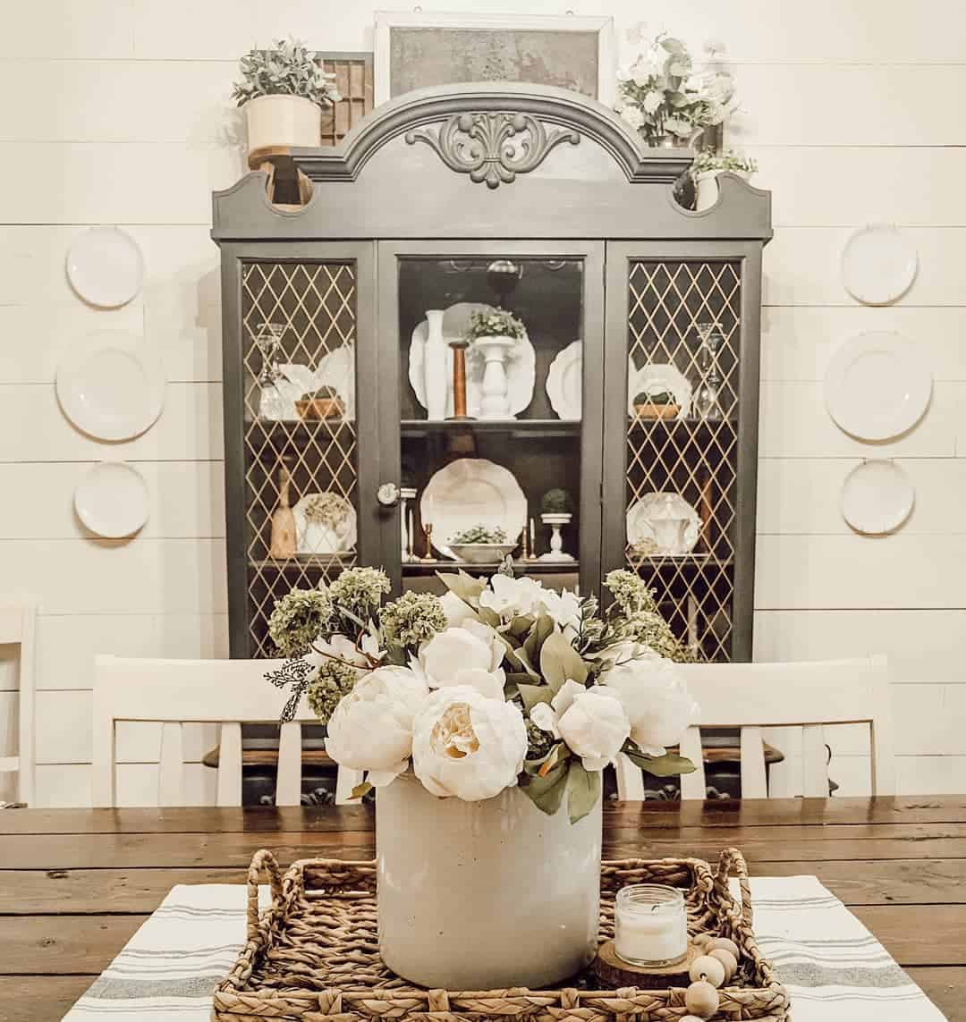 Contrast Dark Cabinet with White Plates and Greenery
