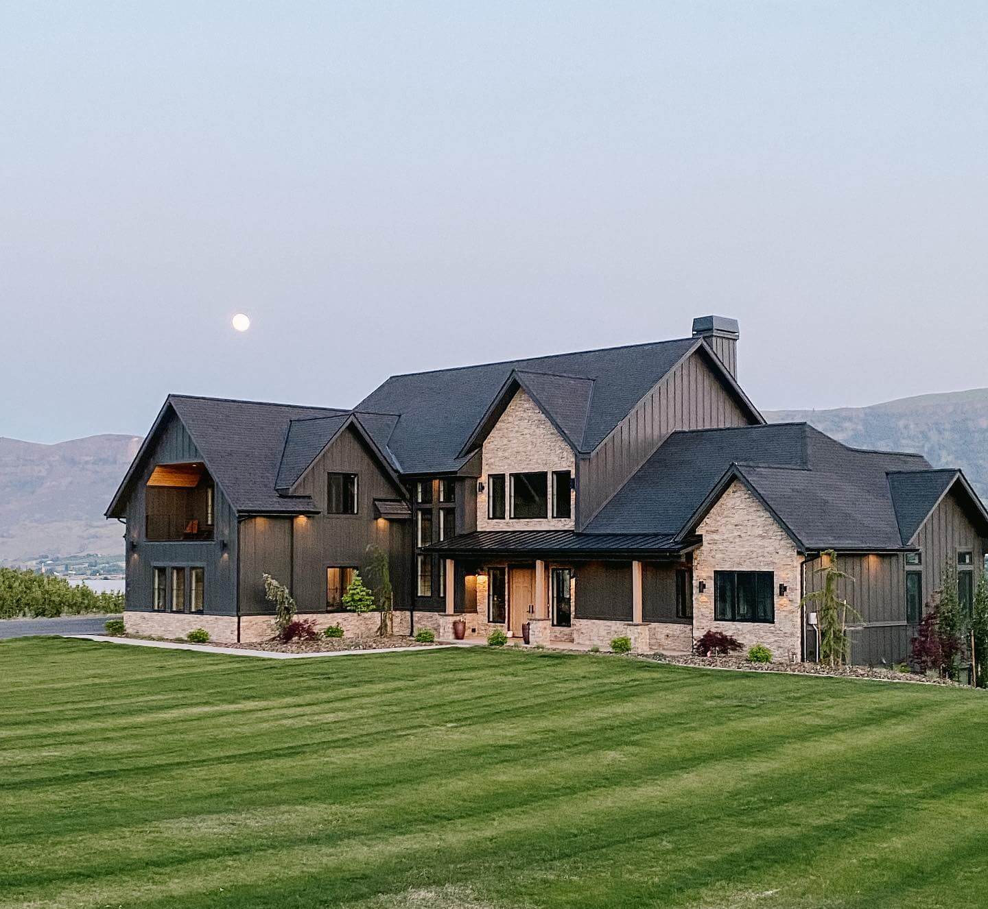 Dark Vertical Siding Creates Striking Contrast on Farmhouse Exterior