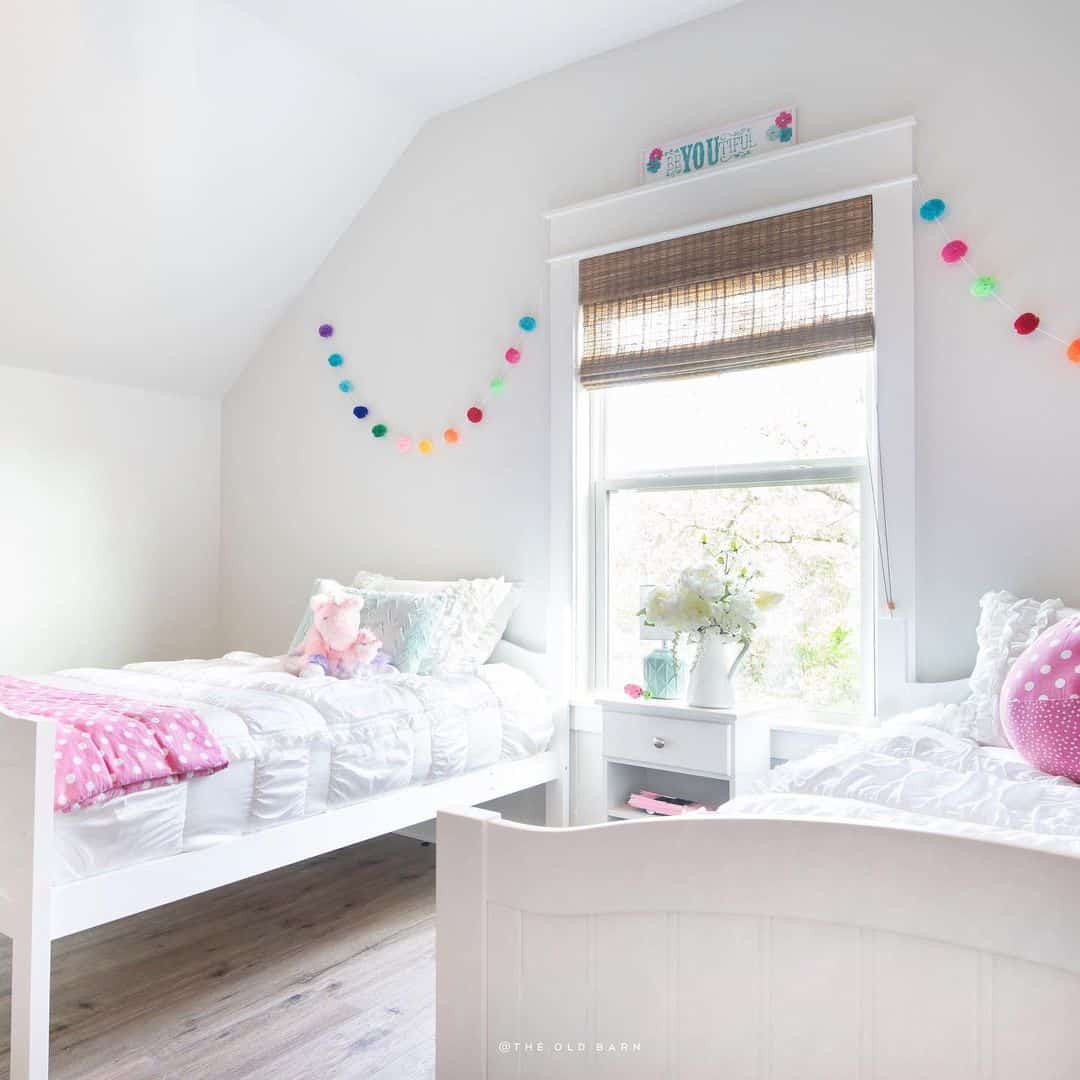 Colorful Pom-Pom Garlands Add Playful Whimsy Above Twin Beds